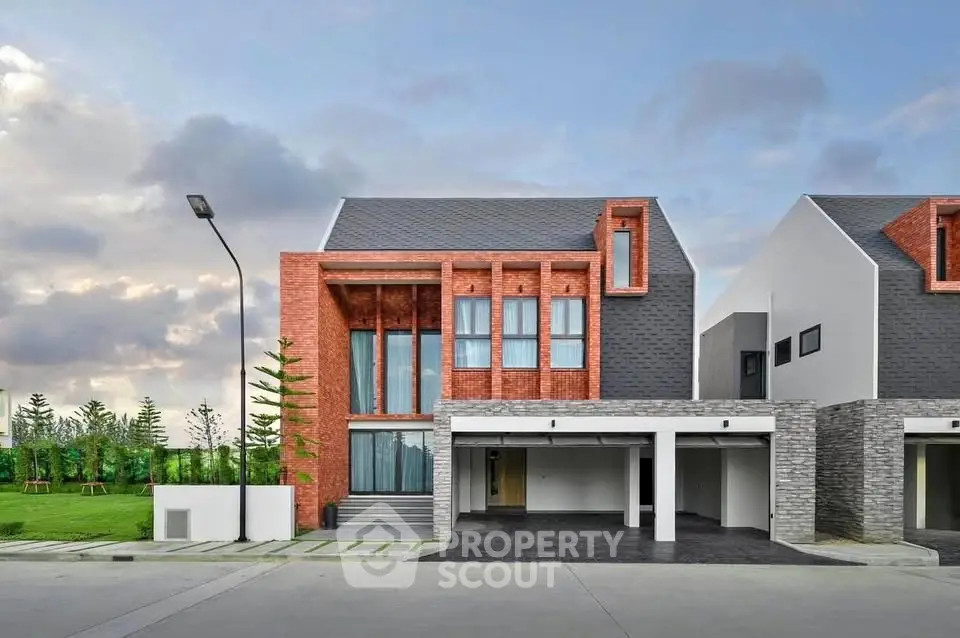 Modern two-story house with unique architectural design and spacious garage.