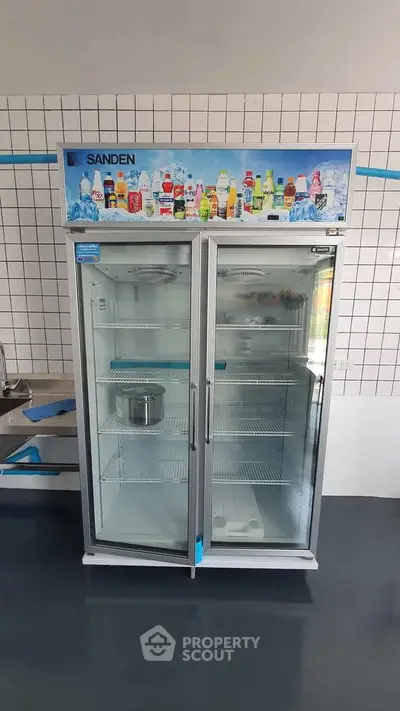 Commercial double-door refrigerator in a modern kitchen setting.