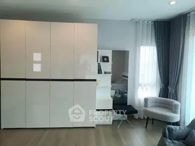 Modern living room with sleek furniture and large windows