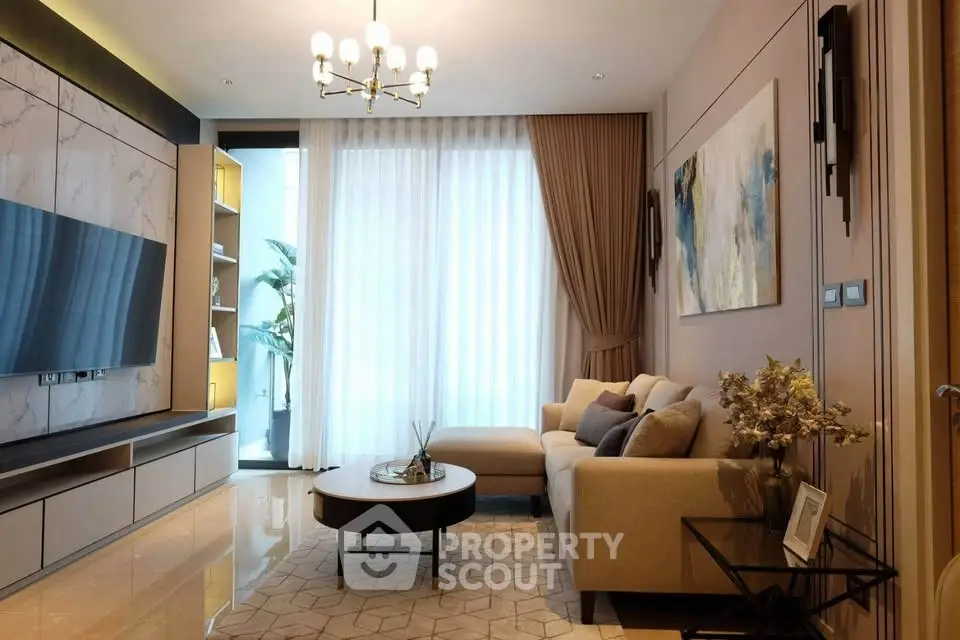 Elegant living room with modern decor, large TV, and natural light from floor-to-ceiling windows.