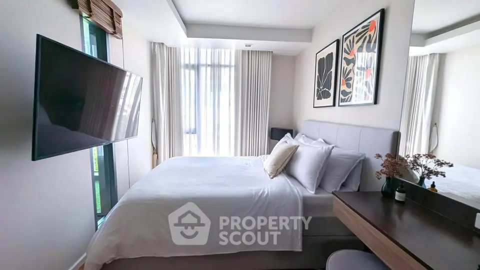 Modern bedroom with stylish decor and large window for natural light