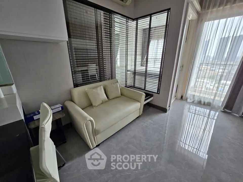 Modern living room with sleek design and large windows offering city views
