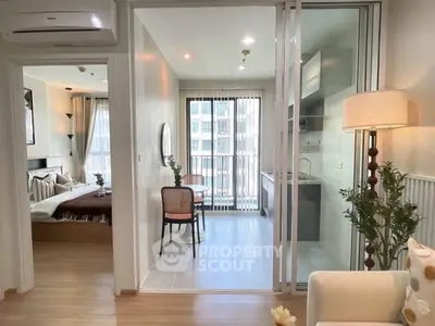 Modern apartment interior with open layout, featuring cozy living area, dining space, and stylish kitchen.