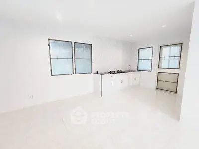 Bright minimalist kitchen with gas stove and ample natural light