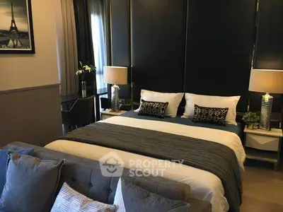 Luxurious bedroom with elegant decor and plush bedding in modern apartment.