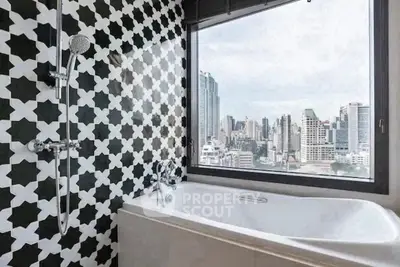 Luxurious bathroom with stunning city view and modern black-and-white tile design.