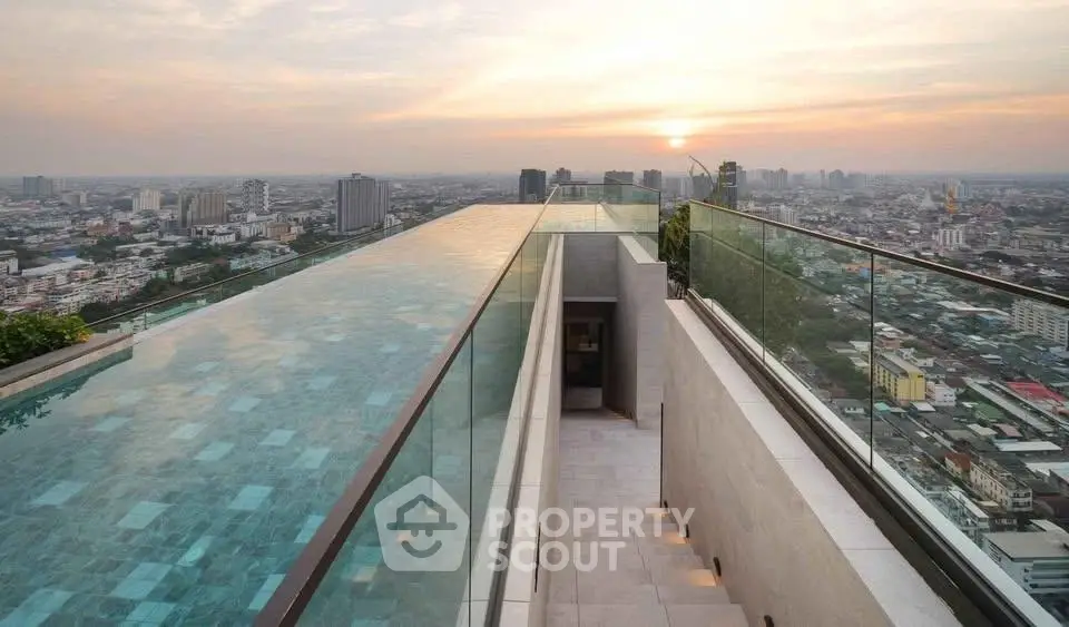 Stunning rooftop infinity pool with panoramic city views at sunset, perfect for luxury living.