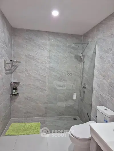 Modern bathroom with glass shower and sleek tile design