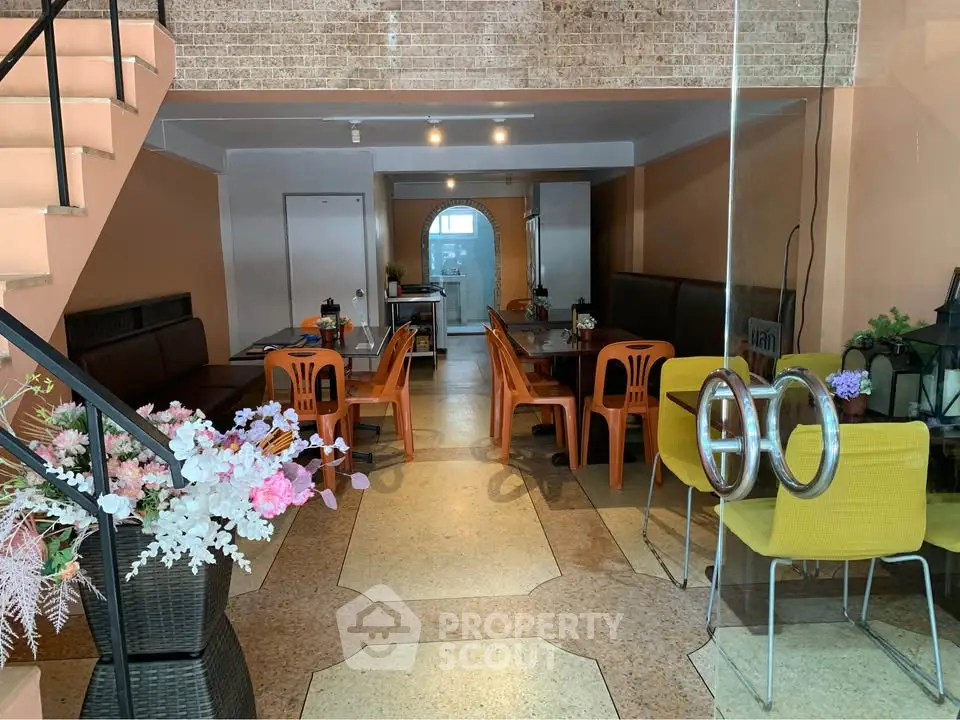 Spacious open-plan living area with modern decor and ample seating, perfect for entertaining guests.