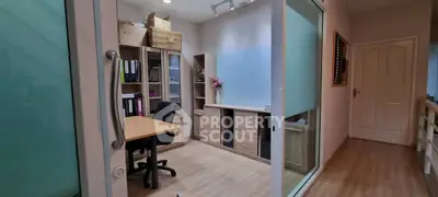 Modern home office with wooden flooring and ample storage space