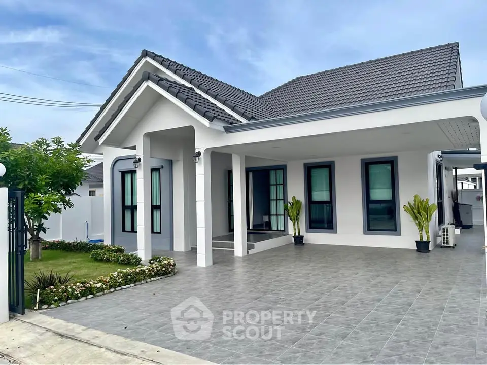 Charming modern house with spacious driveway and lush garden, perfect for family living.