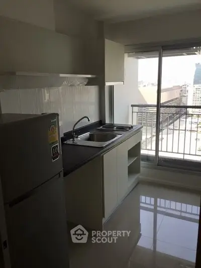 Modern kitchen with balcony view in urban apartment