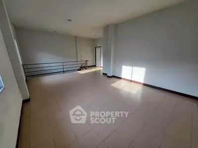 Spacious empty room with natural light and tiled flooring, ideal for customization.