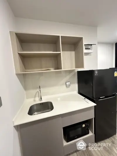 Modern compact kitchen with sleek cabinetry and appliances