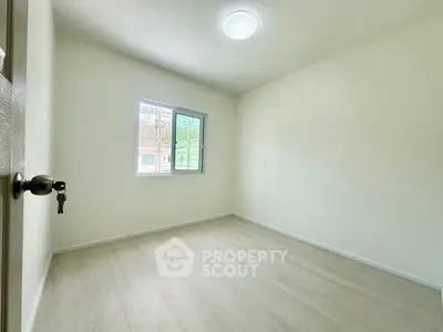 Bright empty room with window and wooden floor, perfect for customization.
