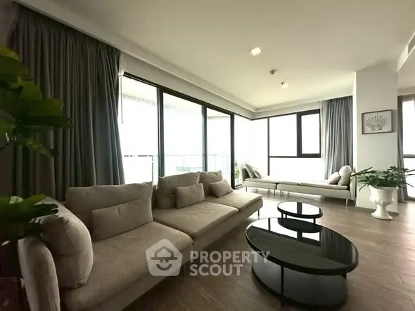 Spacious modern living room with large windows and elegant furniture