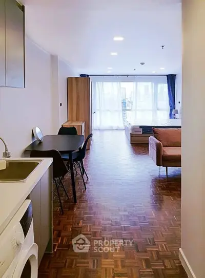 Spacious open-plan living area with modern furnishings and natural light.