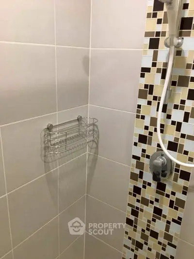 Modern bathroom shower with stylish tile design and chrome fixtures