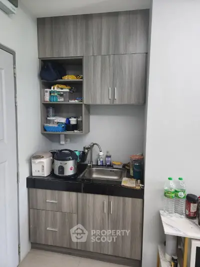 Compact kitchen with modern cabinetry and appliances, perfect for efficient cooking in small spaces.