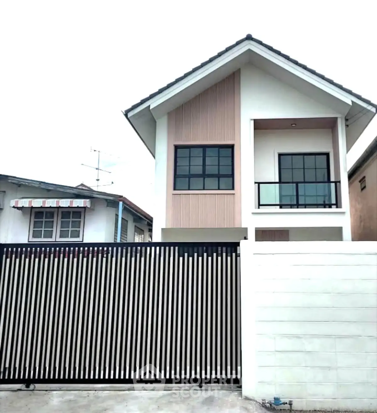 Modern two-story house with sleek design and gated entrance