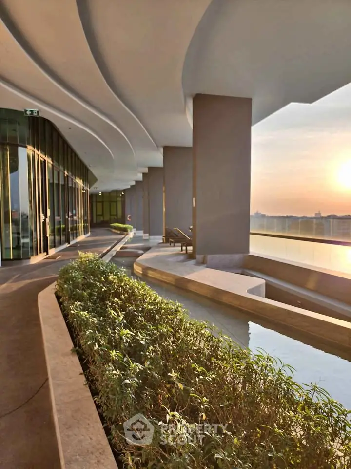 Luxurious building exterior with modern architecture and stunning sunset view.