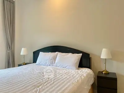 Cozy bedroom with elegant decor and soft lighting, perfect for relaxation.