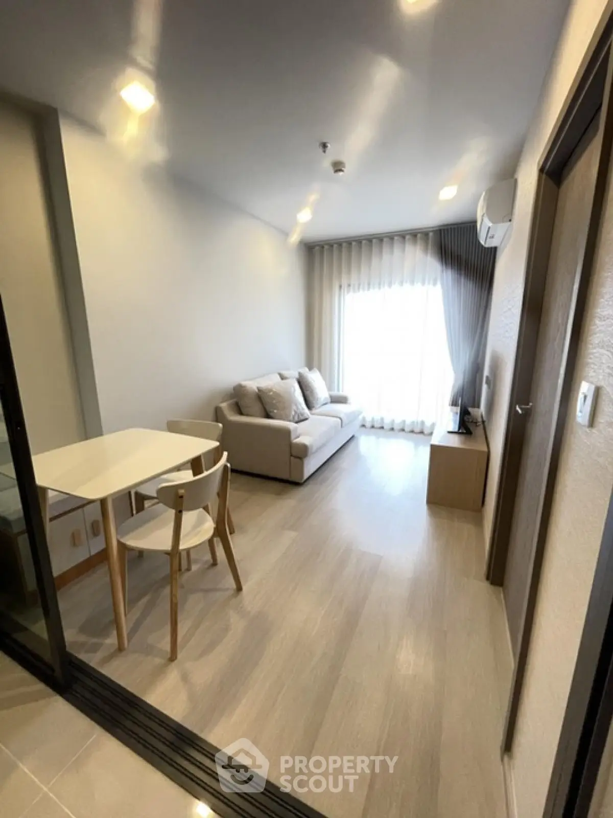 Modern living room with cozy sofa and dining area in bright apartment