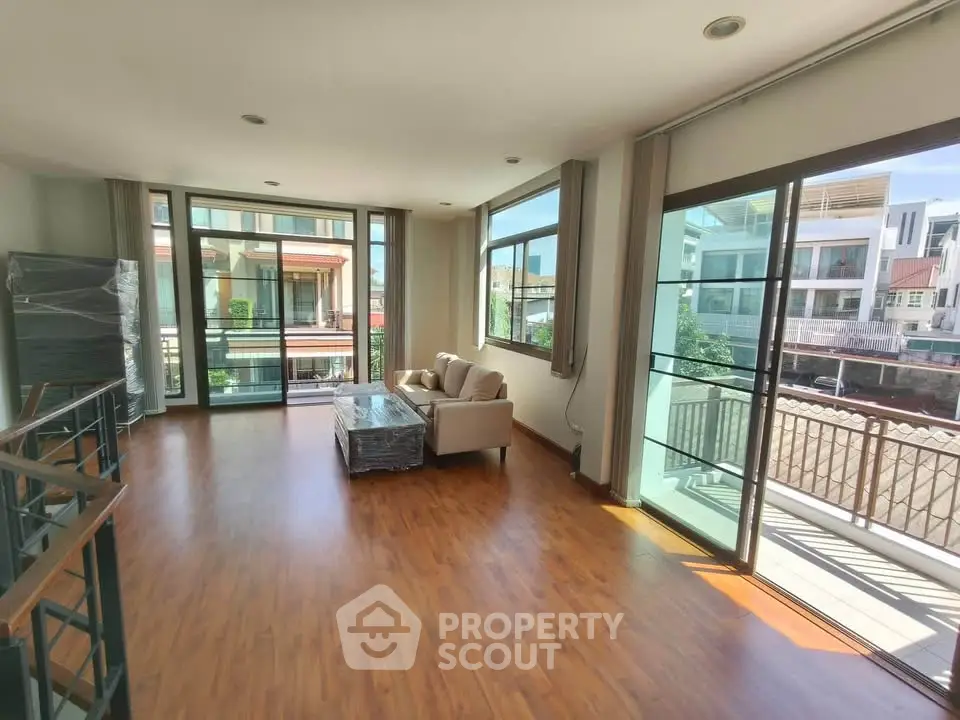 Spacious living room with large windows and balcony in modern apartment