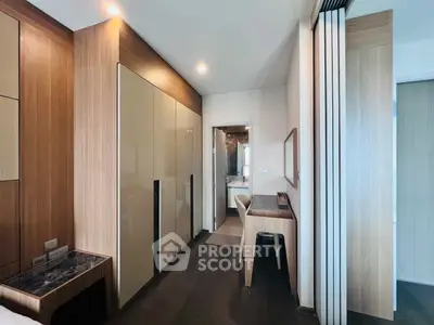 Modern bedroom with sleek wooden furniture and en-suite bathroom