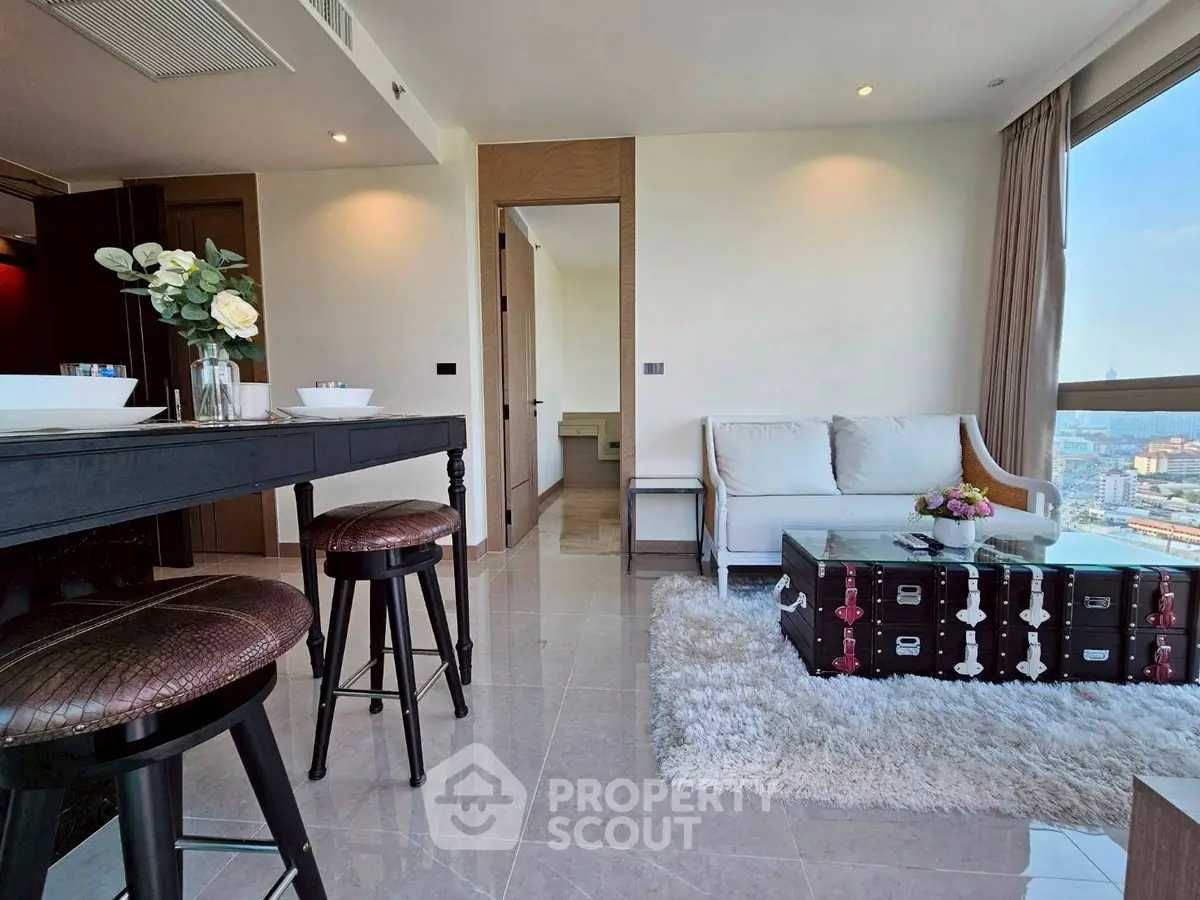 Modern living room with panoramic city view, stylish furniture, and elegant decor in a high-rise apartment.