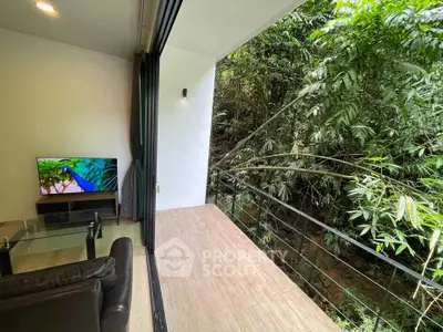 Modern living room with open balcony and lush green view