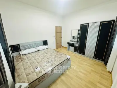 Spacious bedroom with modern furniture and ample storage space