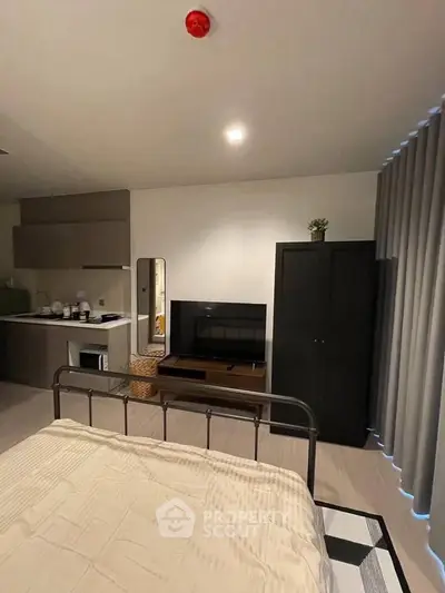 Modern studio apartment with cozy bed, kitchenette, and stylish decor