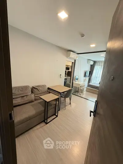 Modern apartment interior with cozy living room and bedroom, featuring stylish furniture and natural light.