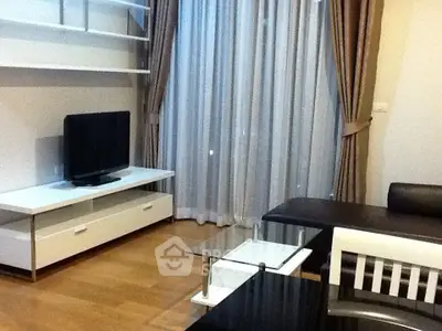 Modern living room with sleek furniture and large window drapes