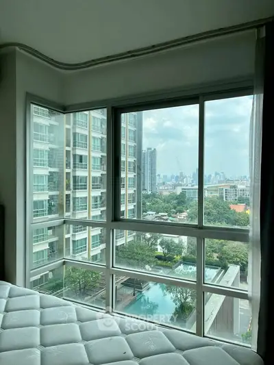 Spacious corner unit with stunning city view and poolside scenery from bedroom window.