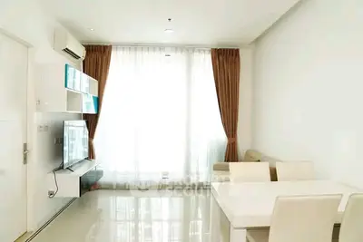 Bright and modern living room with sleek furniture and large window.