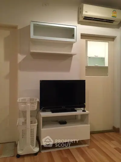 Cozy living room with modern TV setup and air conditioning