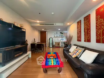 Spacious living room with vibrant decor and open kitchen layout