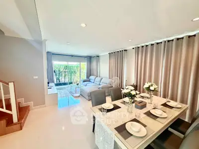 Spacious living and dining area with modern decor and natural light