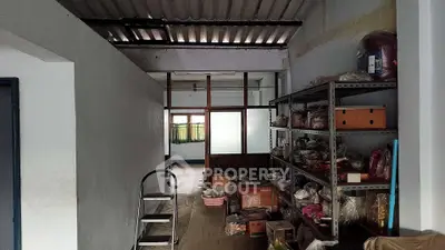 Spacious storage room with shelves and ladder, ideal for organization and inventory management.