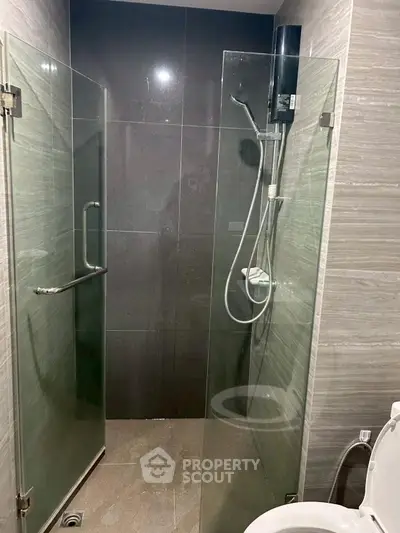Modern bathroom with glass shower enclosure and sleek tile design