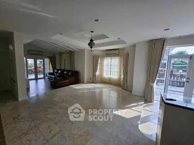 Spacious open living room with large windows and elegant marble flooring