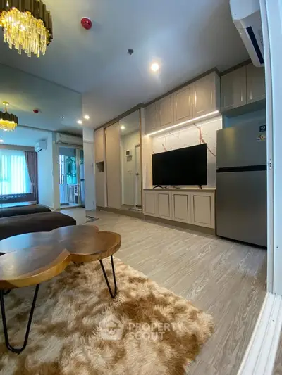Modern living room with stylish decor, plush rug, and open layout in a contemporary apartment.