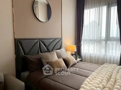 Luxurious bedroom with modern decor and large window offering city views.