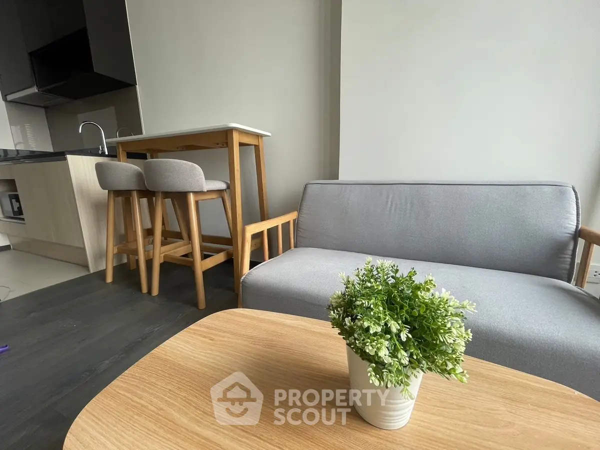 Modern apartment interior with cozy living area and stylish kitchen bar.