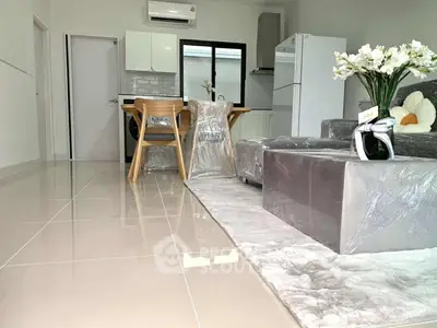 Modern open-plan living room with sleek kitchen and stylish furnishings.