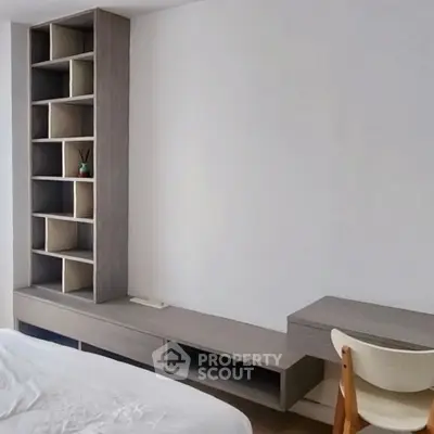 Modern bedroom with sleek built-in shelving and minimalist design