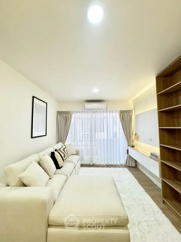 Spacious modern living room with cozy white sofa and elegant decor