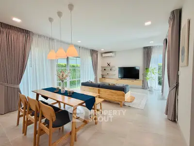 Spacious modern living room with elegant dining area and natural light